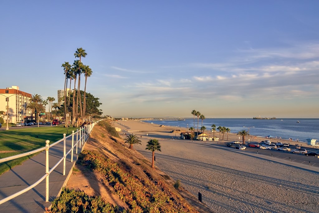 VIew of coastal Long Beach in Southern California at sunset, with sandy beaches and the blue Pacific ocean.