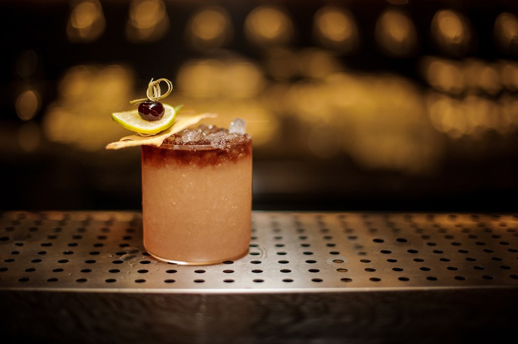 Delicious Mai Tai cocktail in the glass decorated with the one dried pineapple, lime slice and berry.