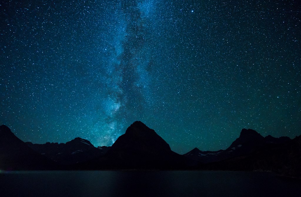 Swiftcurrent Lake  at night under the Milky Way in Many Glacier area of Glacier National Park.