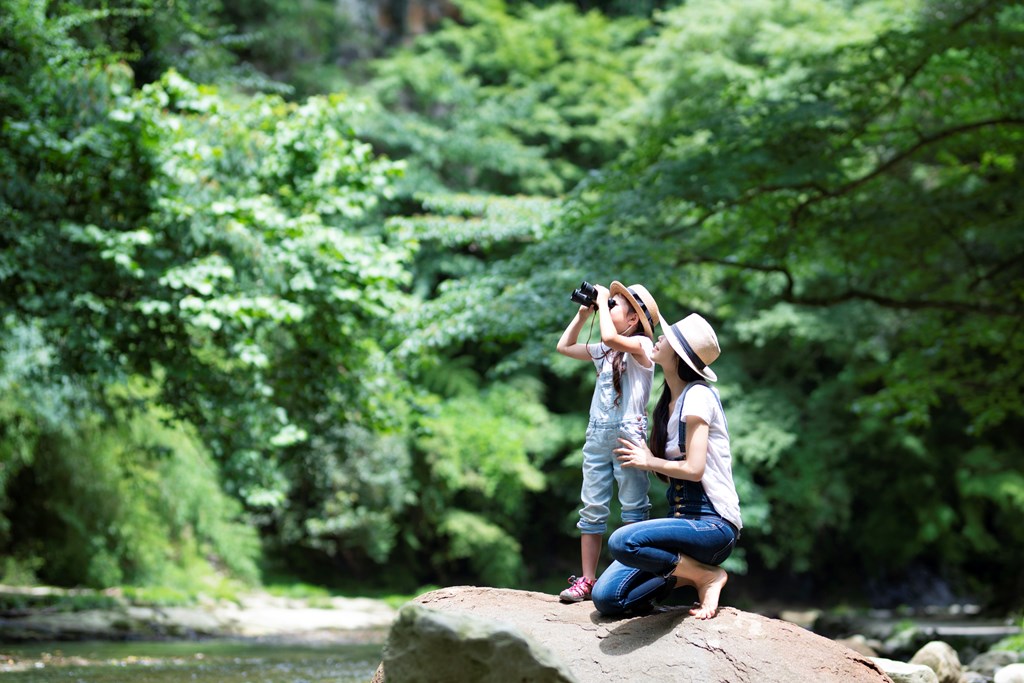 Mother and daughter playing in the river