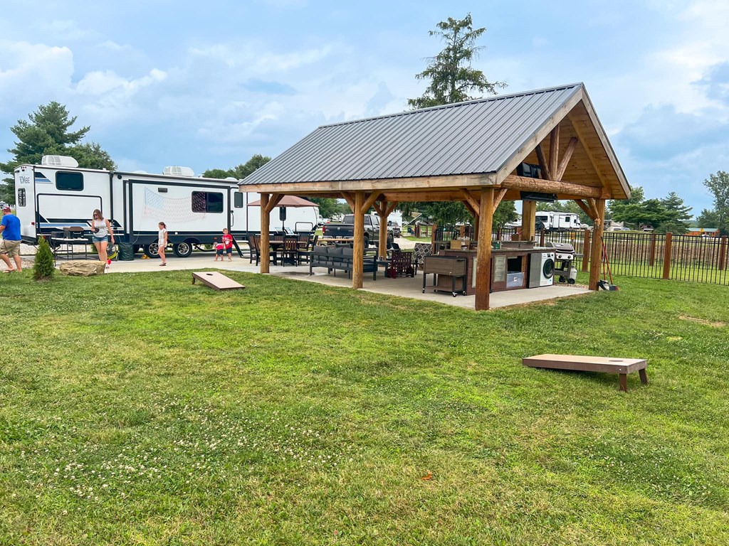 A KOA RV site with covered patio and added amenities.