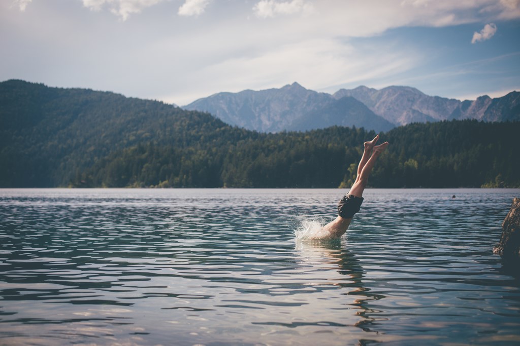 Man diving in a mountain lake.