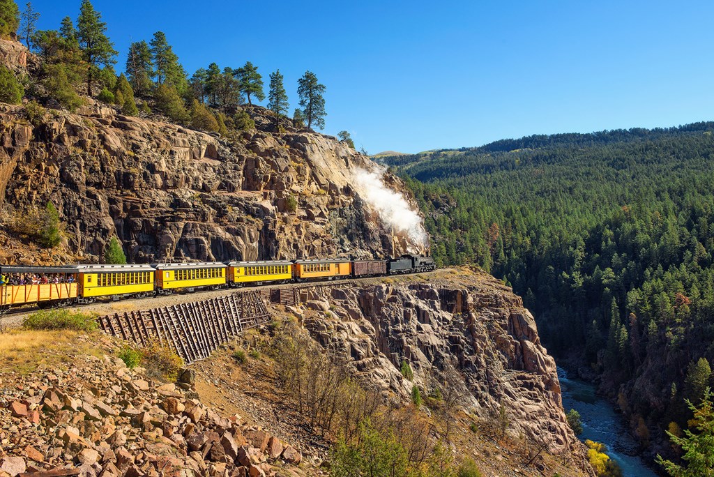 Historic steam engine train travels from Durango to Silverton through the San Juan Mountains in Colorado, USA.