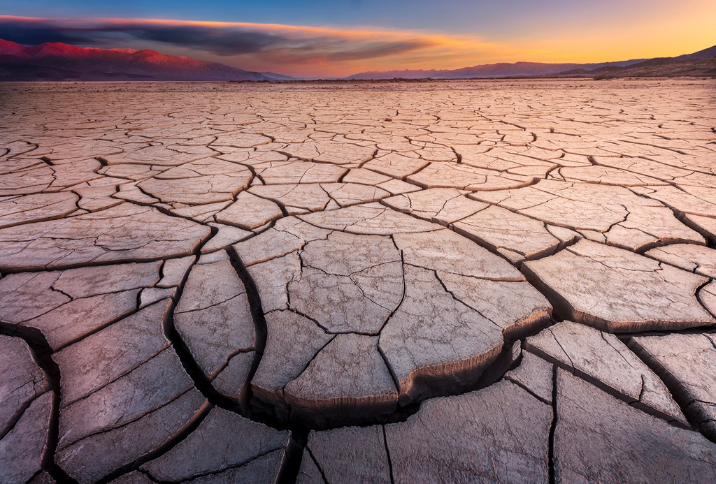 Desolate, cracked mud flat basin in Death Valley National Park.