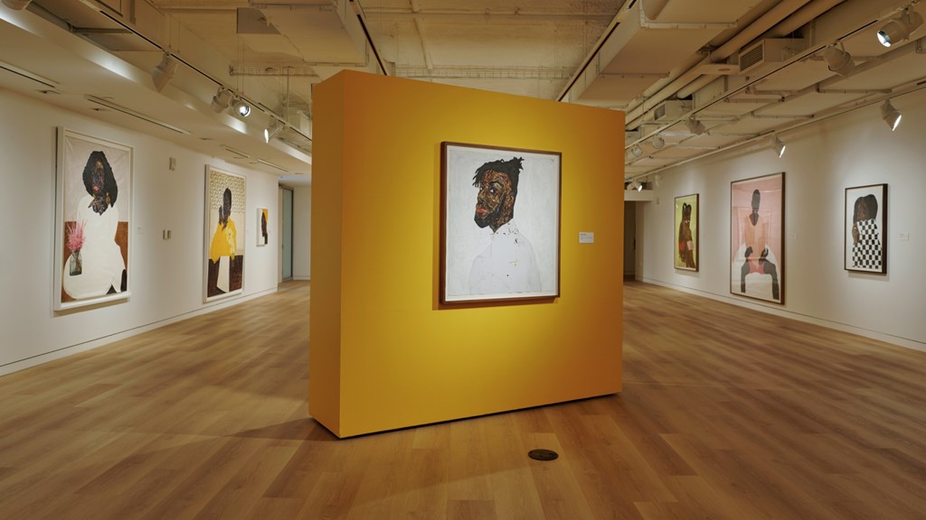 A gallery with large paintings with Black subjects at the Museum of African Diaspora in San Francisco.