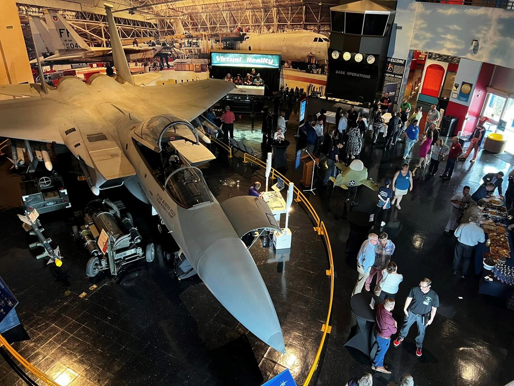 A view of a fighter jet inside an aviation museum.