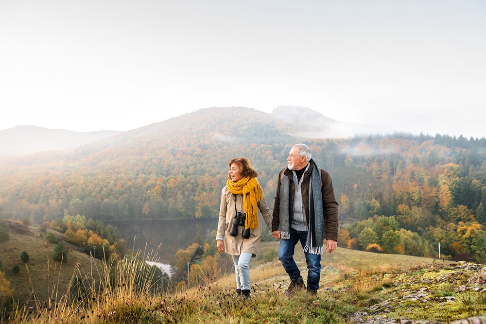 Active senior couple on a walk in autumn.