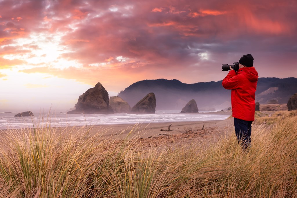 Photographer is taking pictures of the beautiful seaside view on the Oregon Coast. 