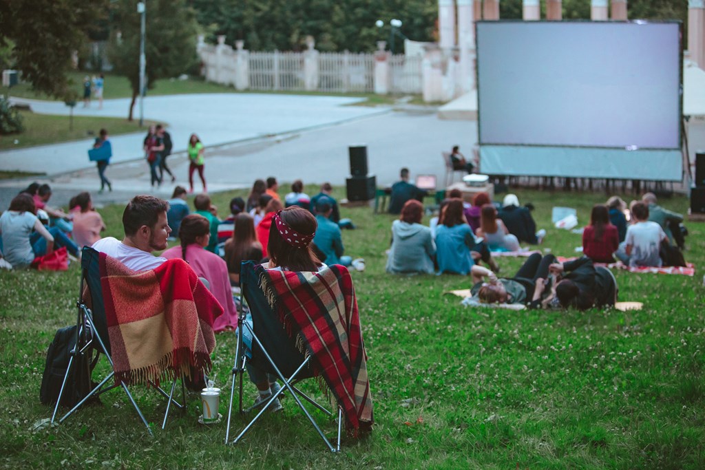 Couple enjoying outdoor movie date during the summer