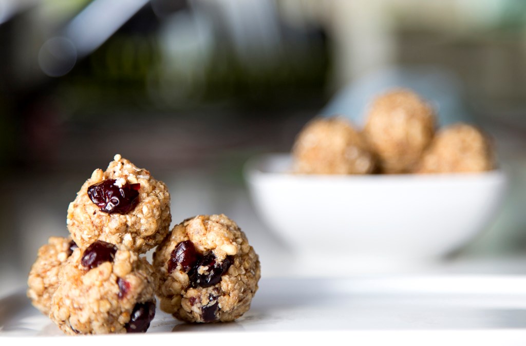 Close up of protein balls made with granola and dried cranberries.