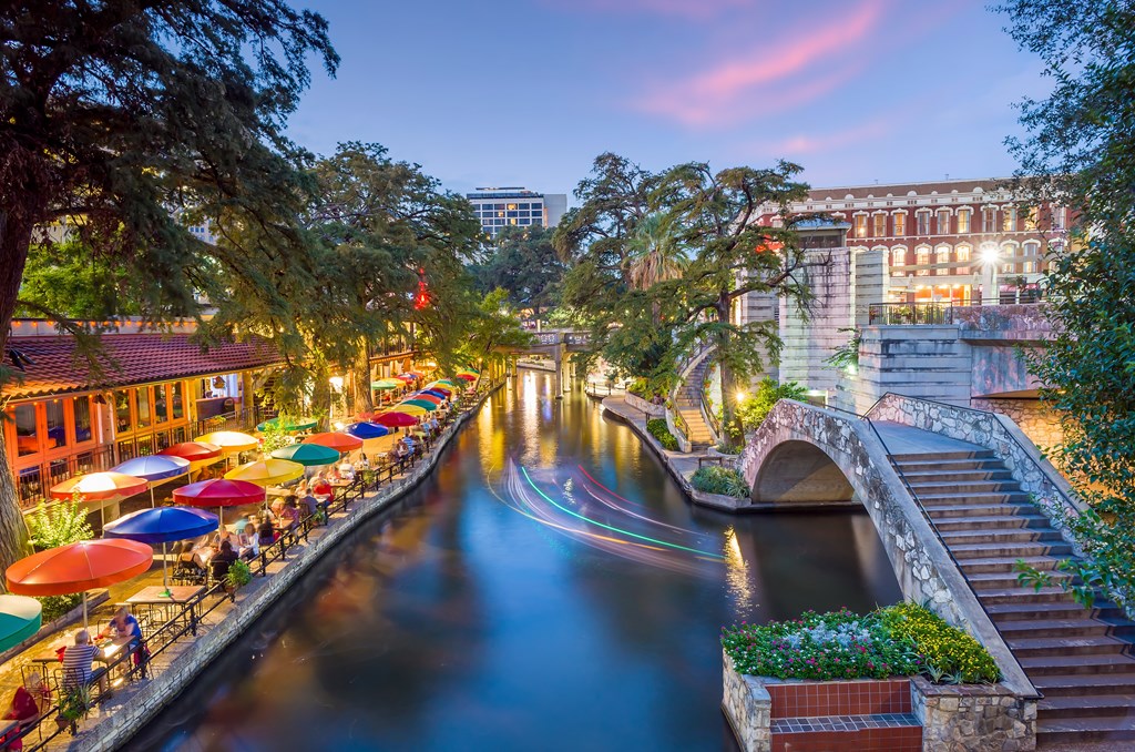 River Walk in San Antonio city downtown skyline cityscape of Texas USA at sunset