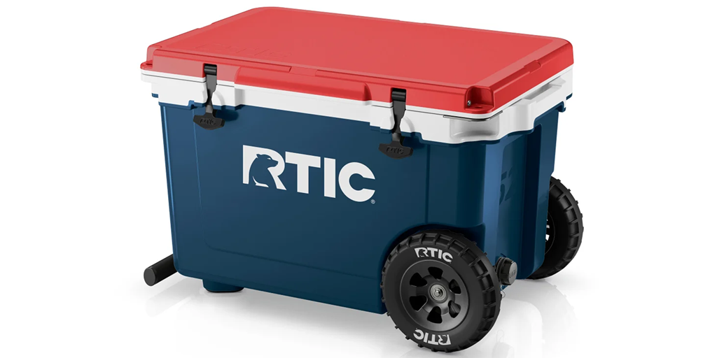 A blue and red cooler with wheels for easy transport.