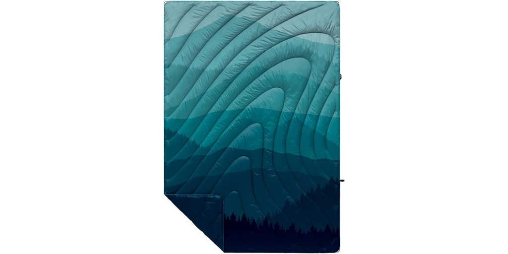 A puffy blanket with a blue gradient mountain design.