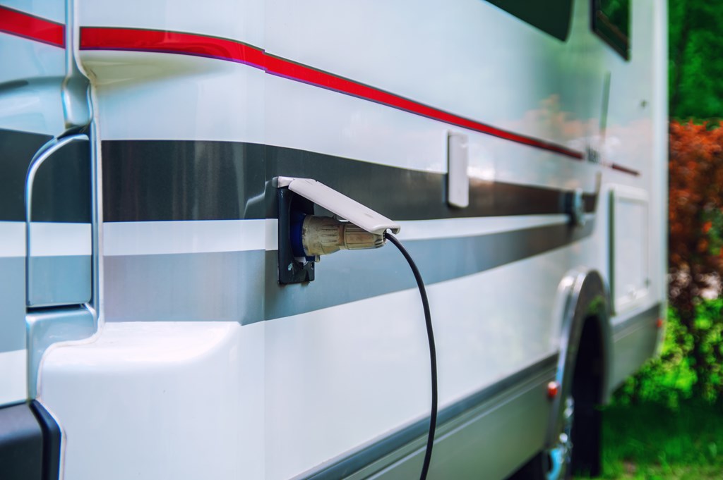 Close up of an RV plugged into electric.