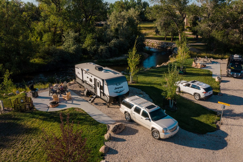 Aerial view of a travel trailer RV on a back-in KOA Patio Site.