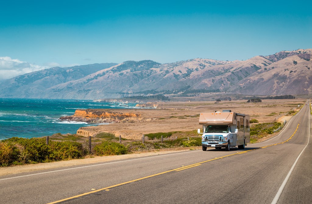 Panorama view of recreational vehicle driving on famous Highway 1 along the beautiful Central Coast of California, Big Sur, USA.