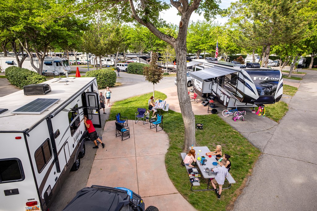 An aerial photo of two families enjoying the campground near their RVs.