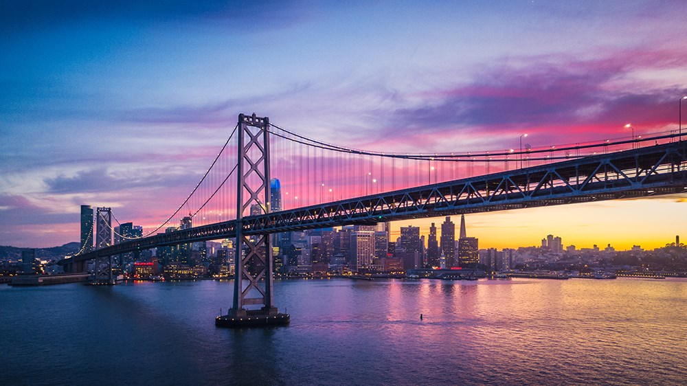 Aerial Cityscape view of San Francisco and the Bay Bridge with Colorful Sunset, California, USA