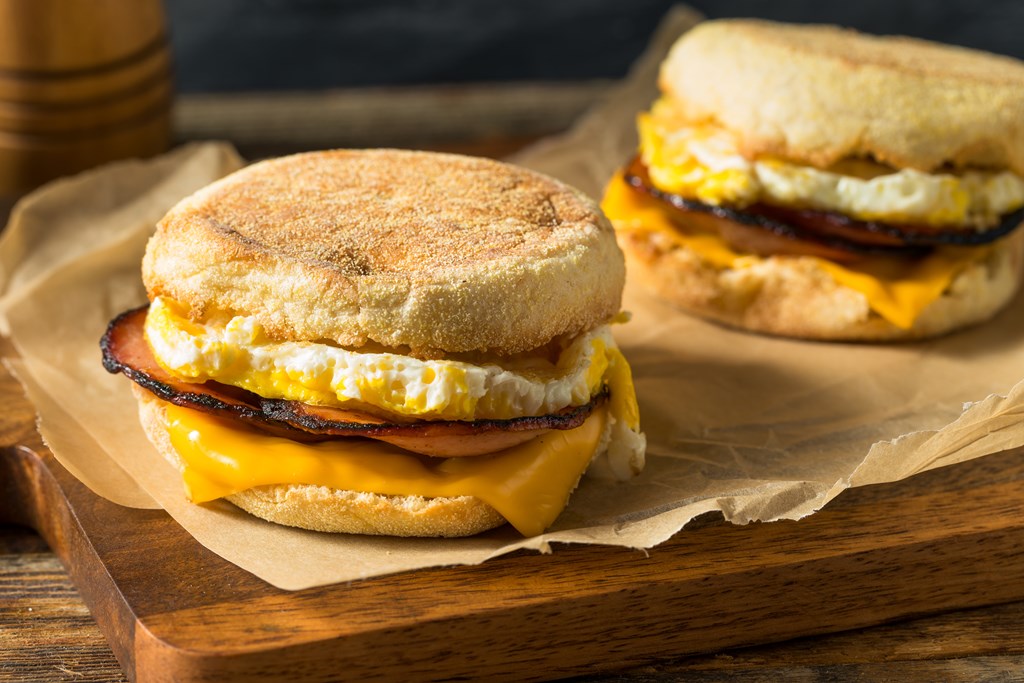 Homemade English muffin breakfast sandwich with sausage, egg and cheese.