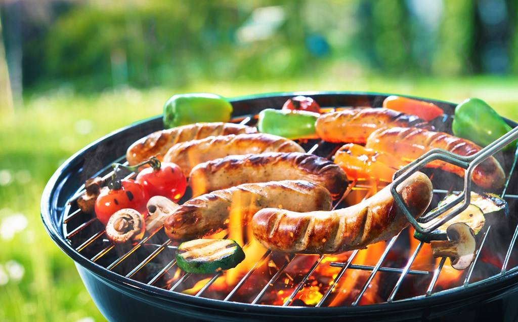 Grilled sausage on the flaming grill