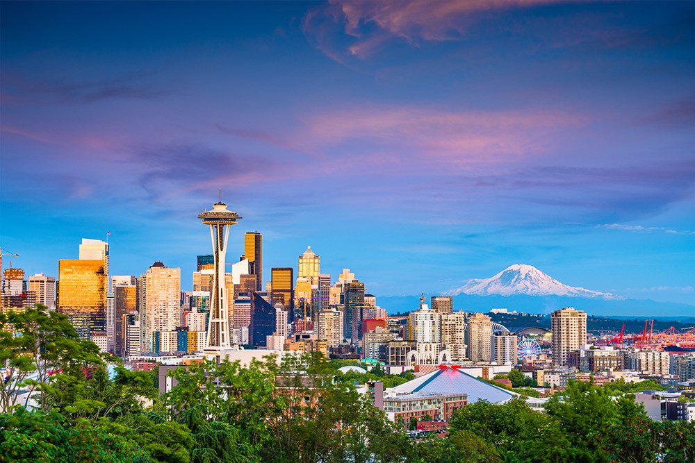 Seattle, Washington, USA downtown skyline at night with Mt. Rainier.