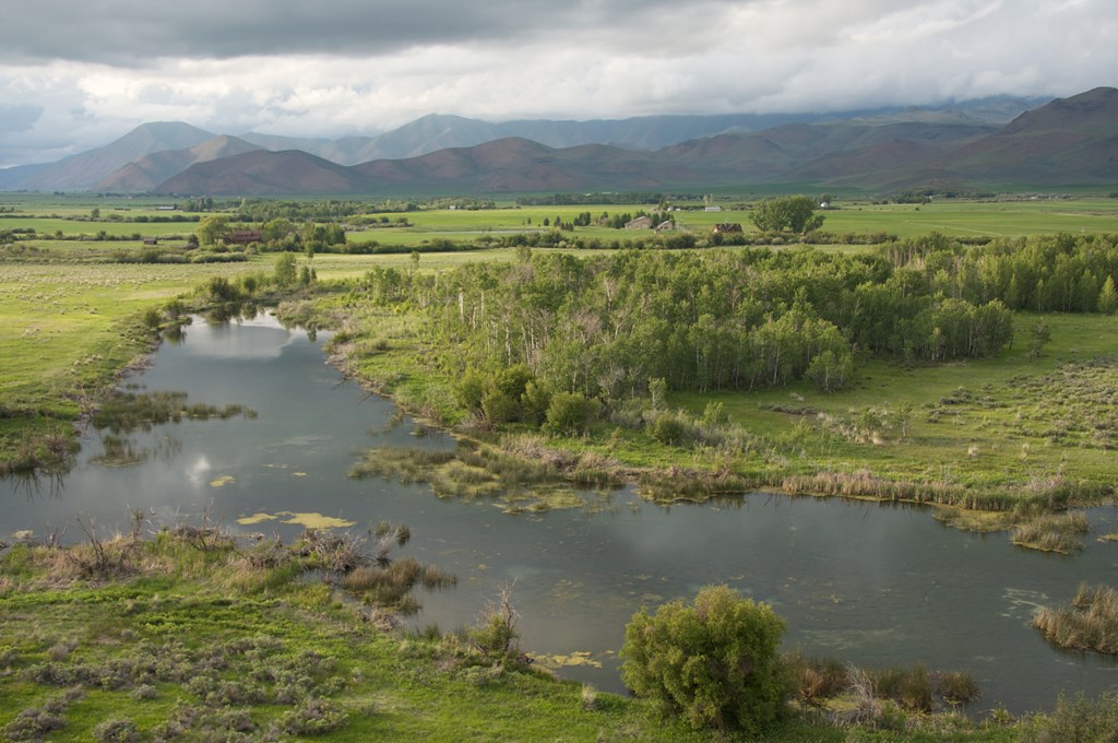 A small stream in a cloudy mountain valley