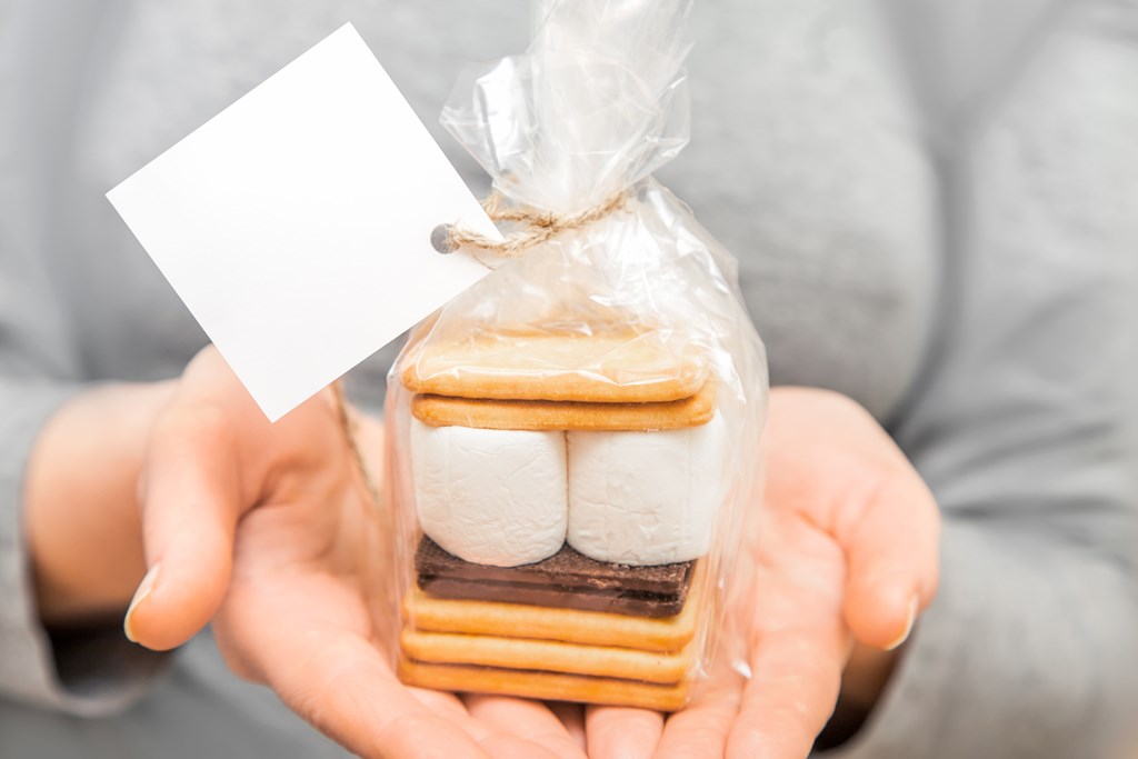 The ingredients to make s'mores in a small gift bag.