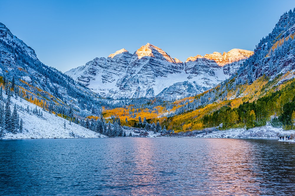 Snow-capped Maroon Bells at sunrise in fall, Apen, CO