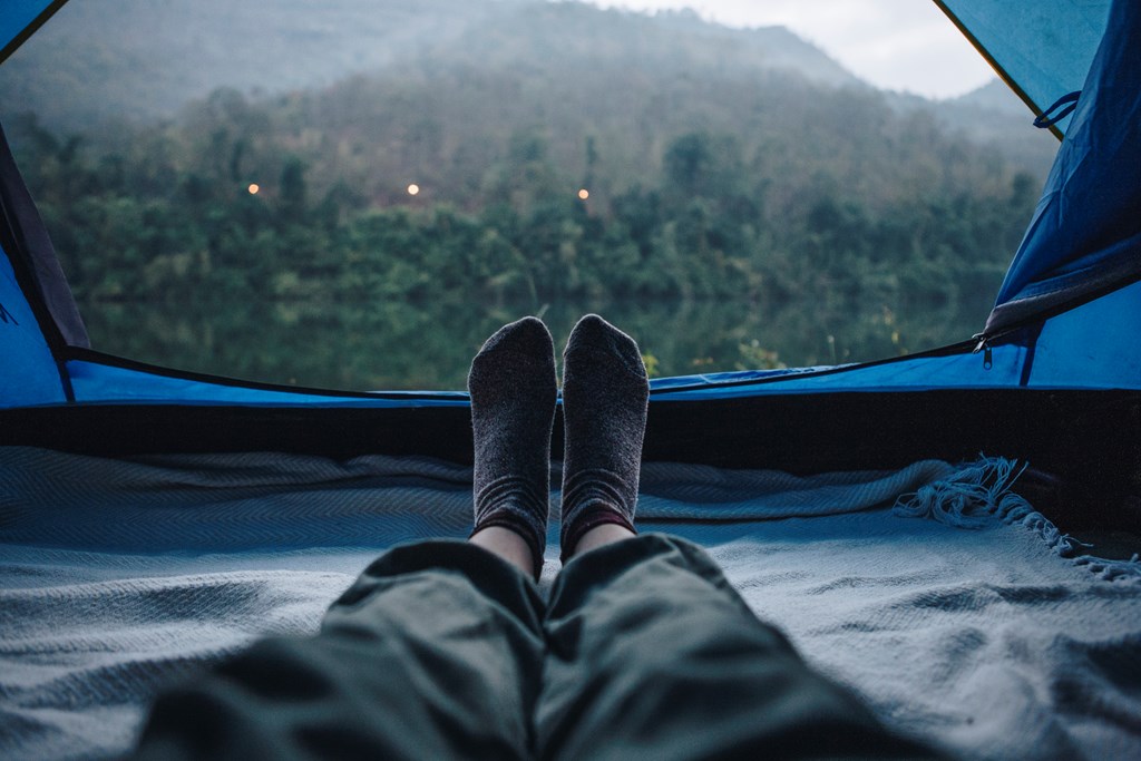Woman sleeping in a tent with an amazing view.