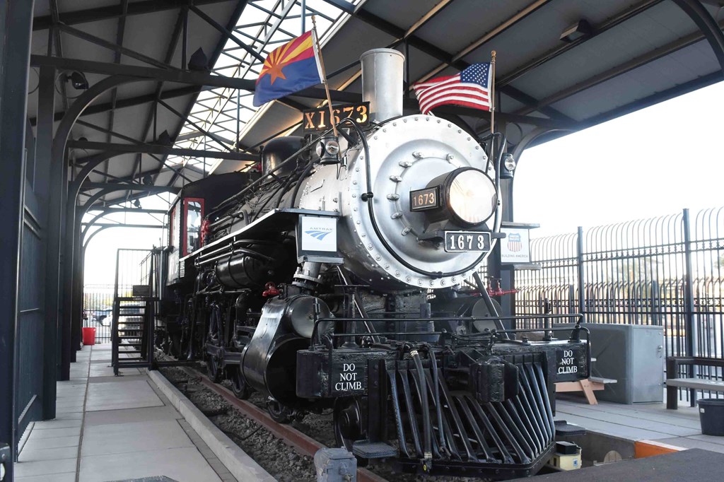 An antique steam locomotive on display at a museum.