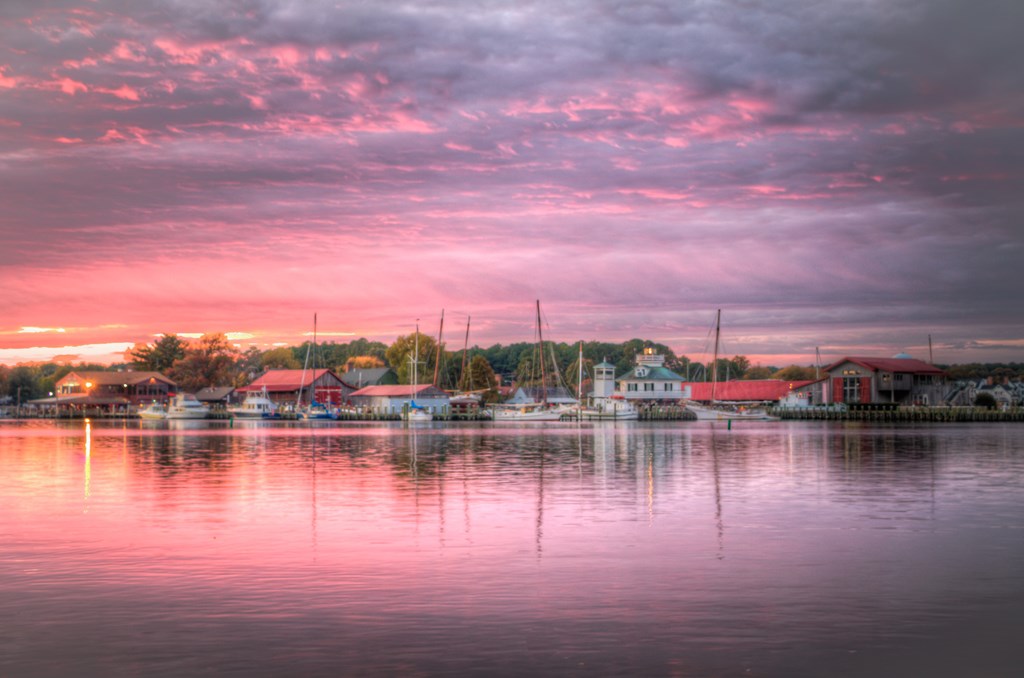 A purple sunset over the harbor with boats in St. Michaels, Maryland.