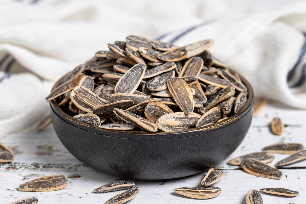 Sunflower seeds on wood background. Salted sunflower seeds. 