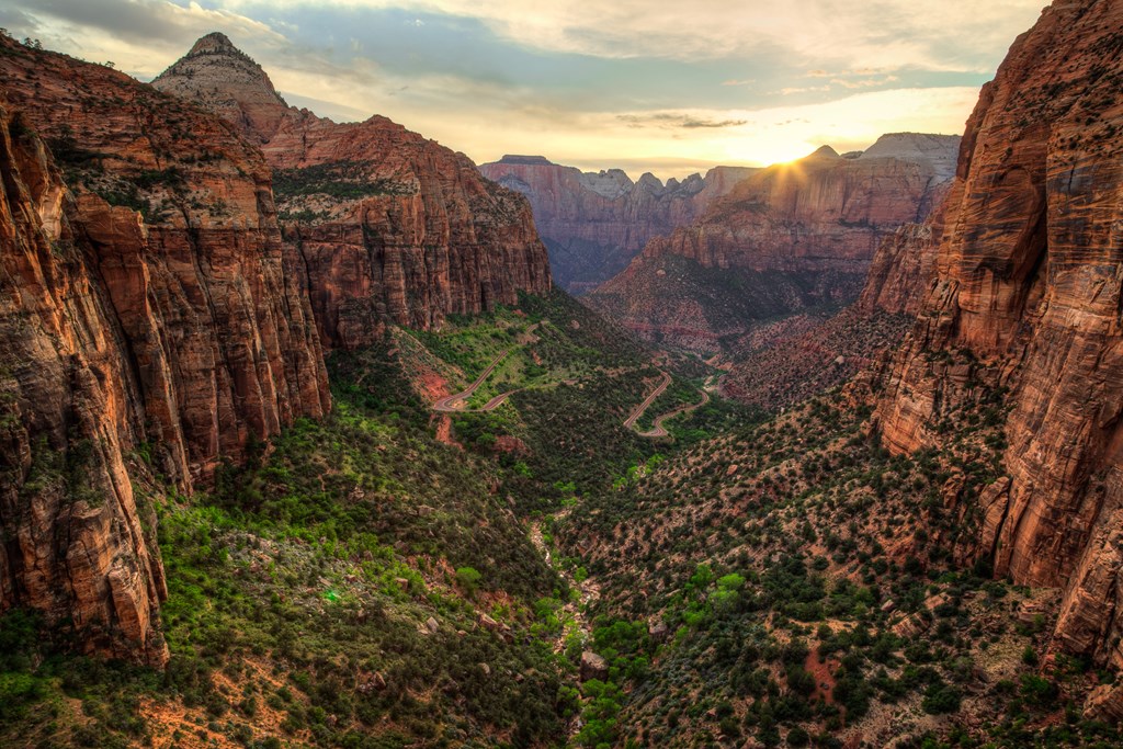 The sun sets over the red rock canyons of Zion National Park.