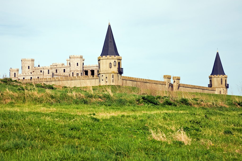 The turrets of the Kentucky Castle are visible on a grassy hill.