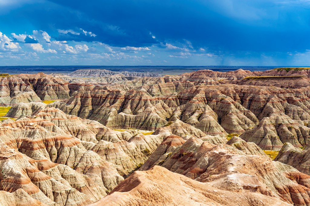 A thunderstorm inside Badlands national park with the rock formations illuminated by sunlight near Rapid City, South Dakota, USA.