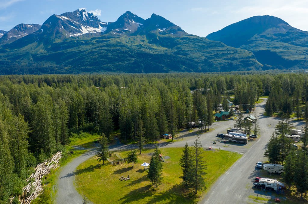 An aerial view of the Valdez KOA with stunning mountains and forest int he background.
