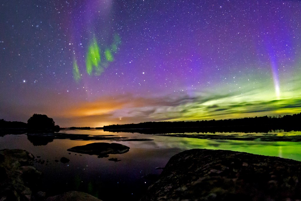 The Northern Lights glowing over the waters of Voyageurs National Park in Minnesota.