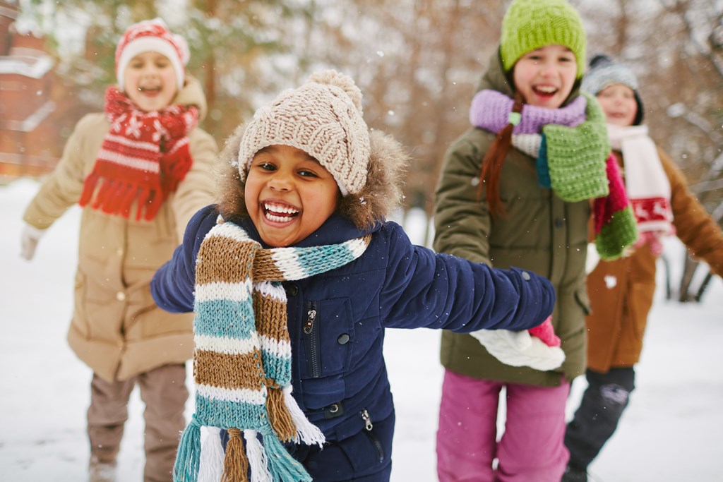 Cheerful girl and her friends spending time outdoors