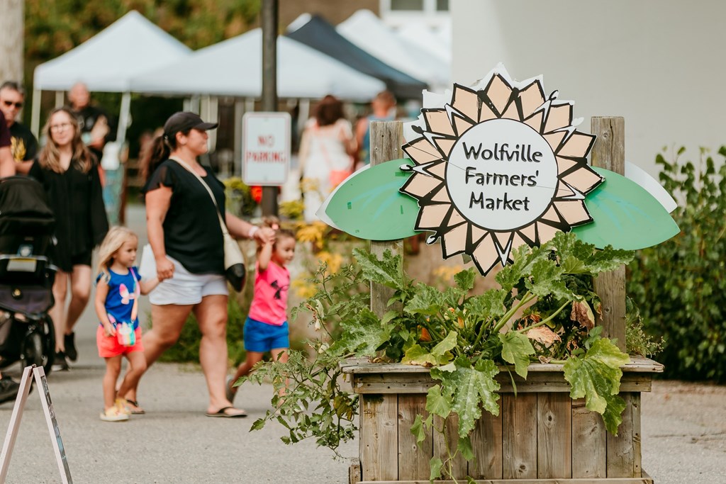 A sign welcoming shoppers to the Wolfville Farmer's Market.
