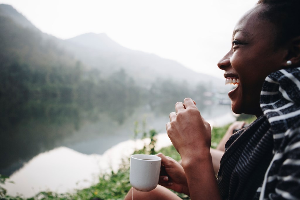Woman enjoying morning coffee with nature