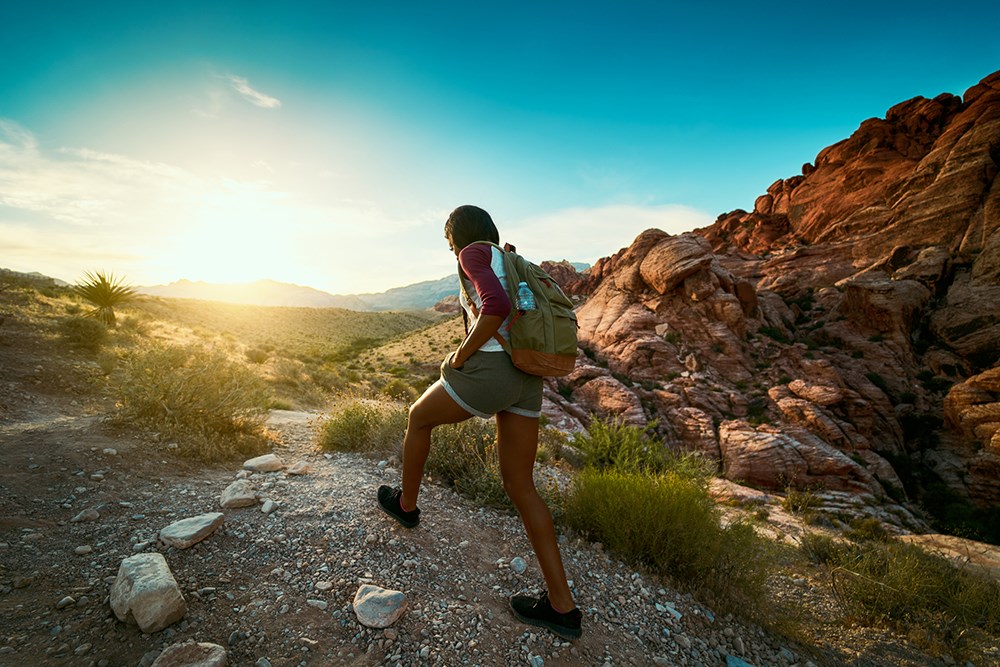 woman hiking at Red Rock Canyon during sunset 