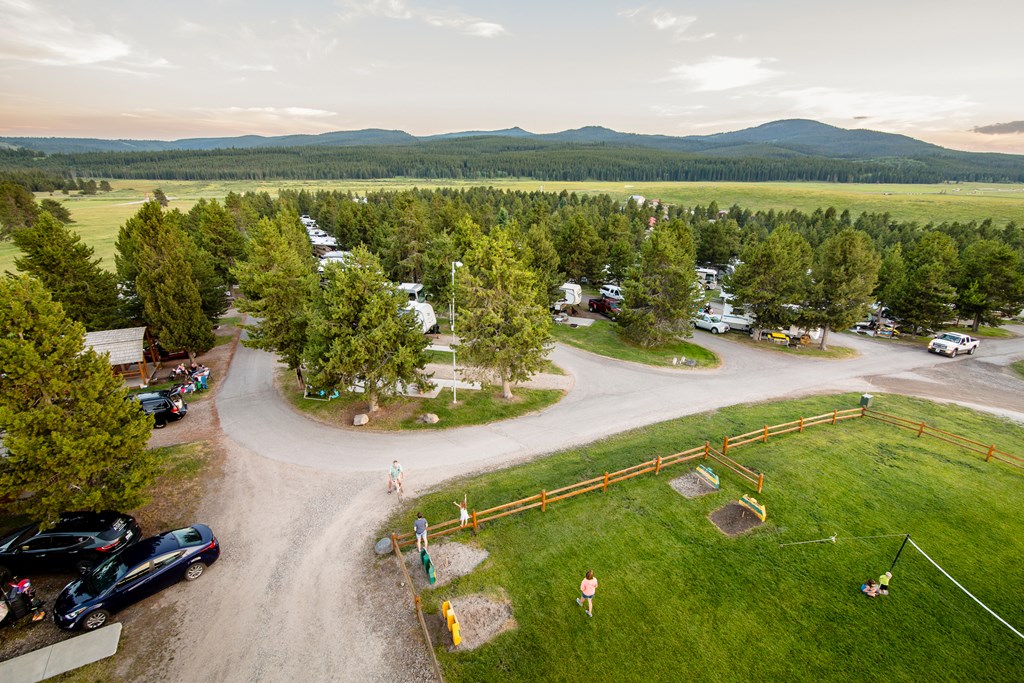 An aerial view of a campground with mountains in the distance.