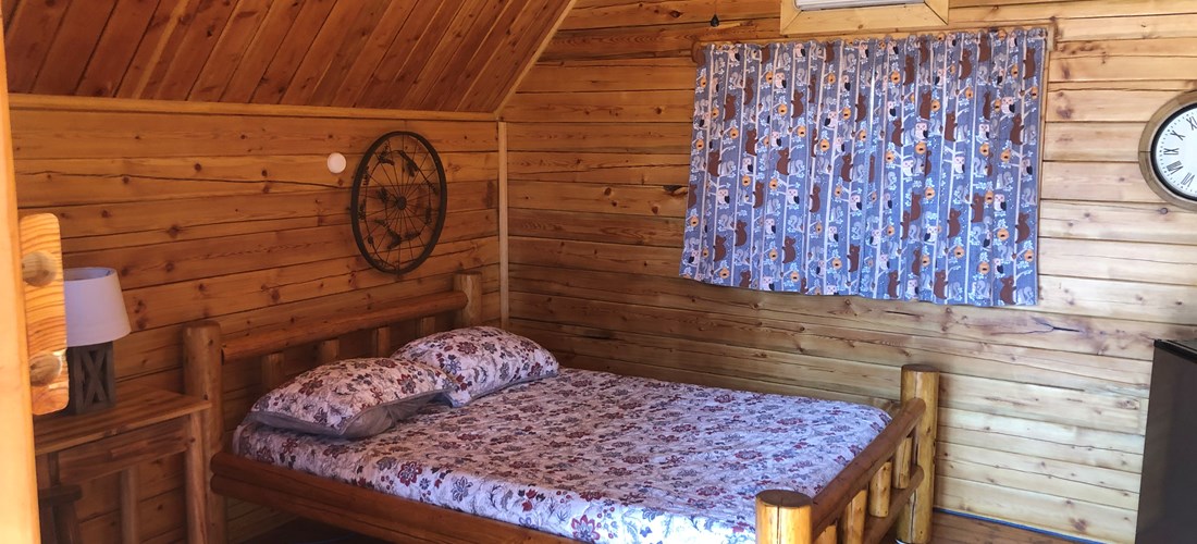 1 Room Camping Cabin (w/o Bathroom) Our couples cabin is ready for your next getaway in the heart of Texas. Comfortable cabin has one full bed, seating, mini-fridge, TV with upgraded cable and heat/air-conditioning. Handicap accessible. Schedule your get-a-way now!