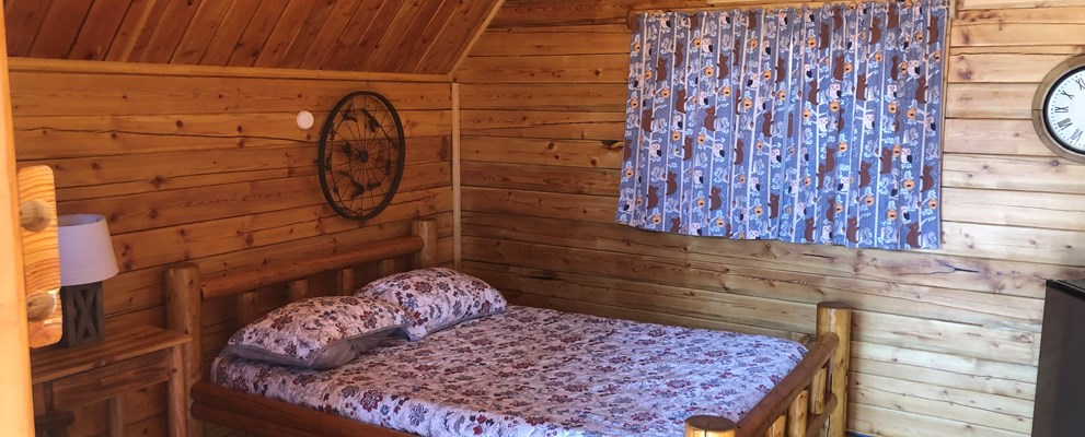 1 Room Camping Cabin (w/o Bathroom) Our couples cabin is ready for your next getaway in the heart of Texas. Comfortable cabin has one full bed, seating, mini-fridge, TV with upgraded cable and heat/air-conditioning. Handicap accessible. Schedule your get-a-way now!