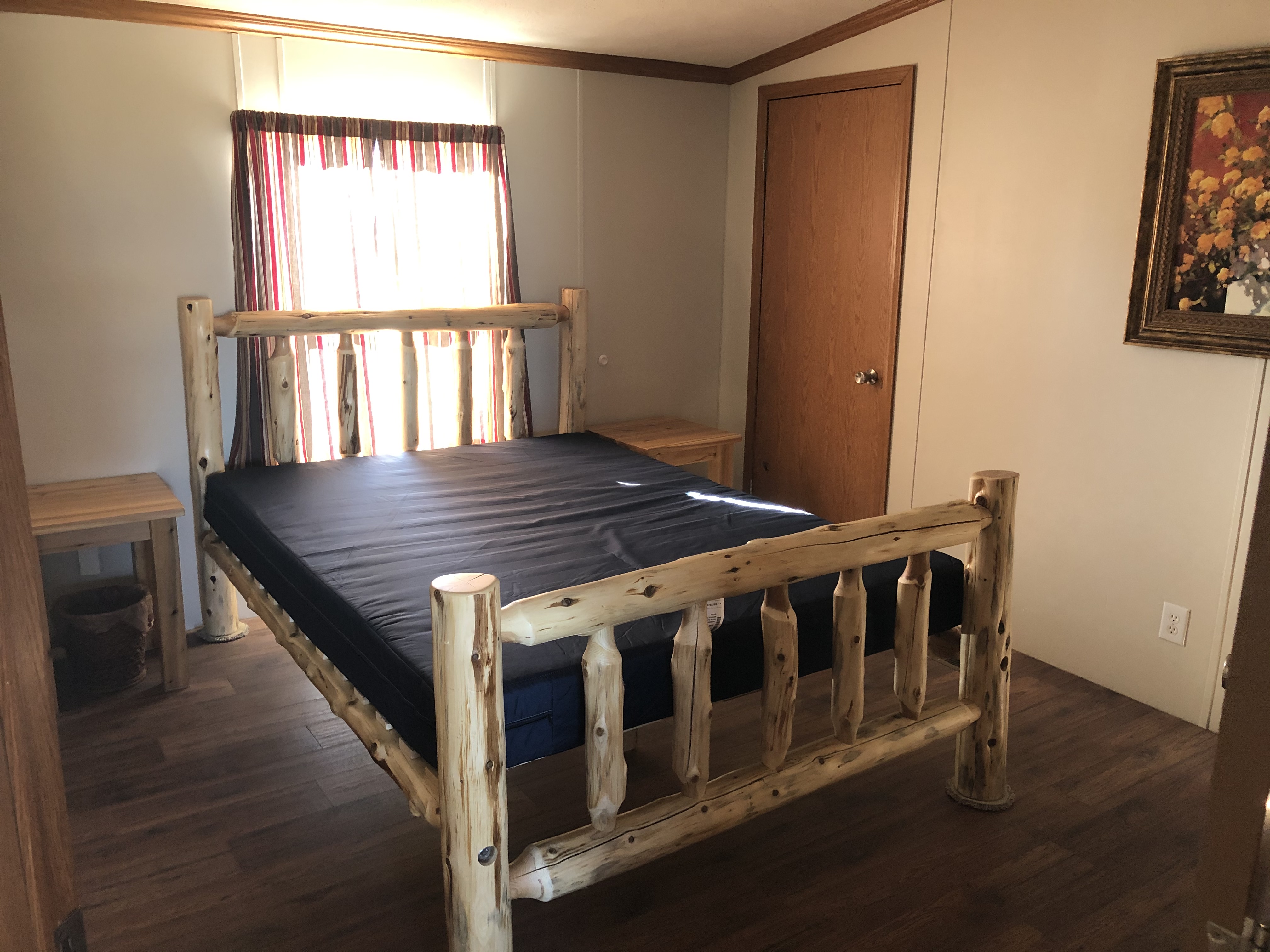 Bunkhouse master bedroom with log queen bed