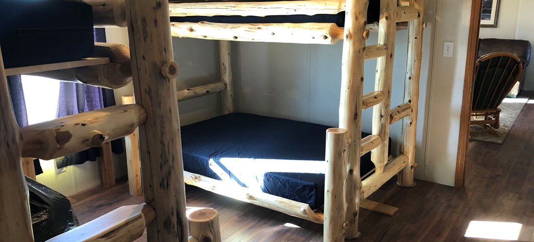 Bedroom #3 with two log bunkbeds .  Full on bottom, twin on top.