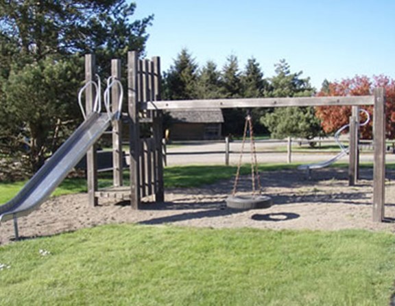 The playground is near the pool and mini-golf course