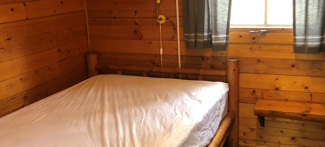 One room Cuddle Cabin full-size bed. Bring your linens, towels, and other personal items.
