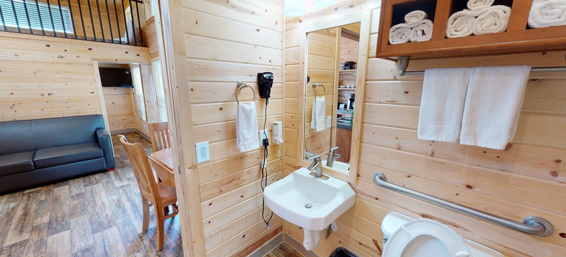 ADA Deluxe Cabin Bathroom complete with towels and a hair dryer