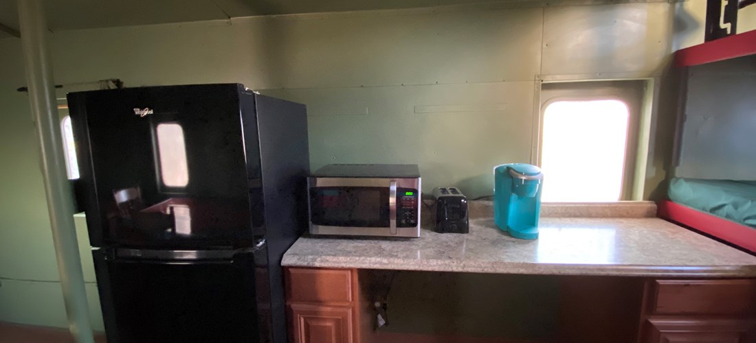 Partial Kitchen includes microwave, toaster, and Keurig coffee maker.